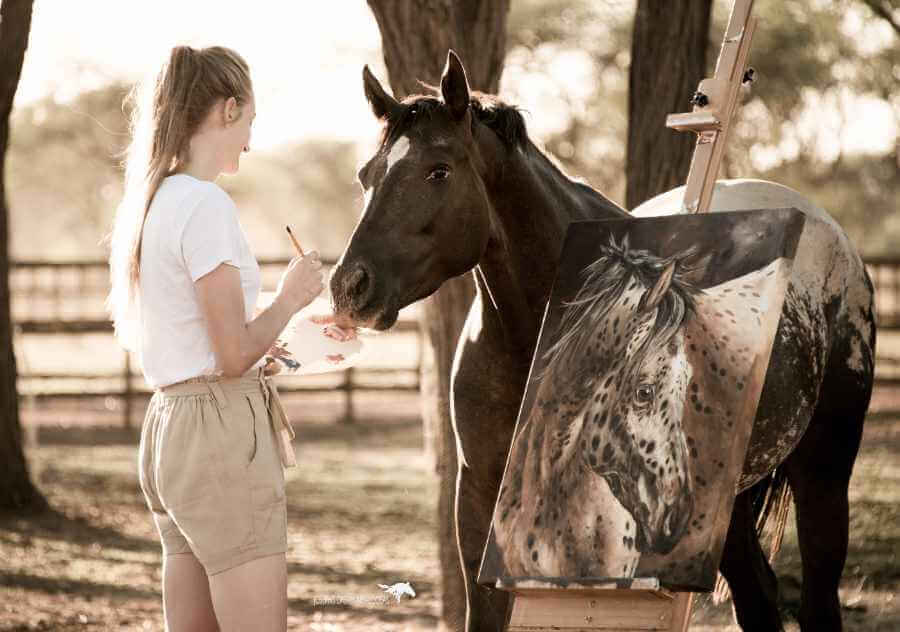 An artist works on her masterpiece in the horse paddocks at Joseph's Dream Stud on Sandwerf.