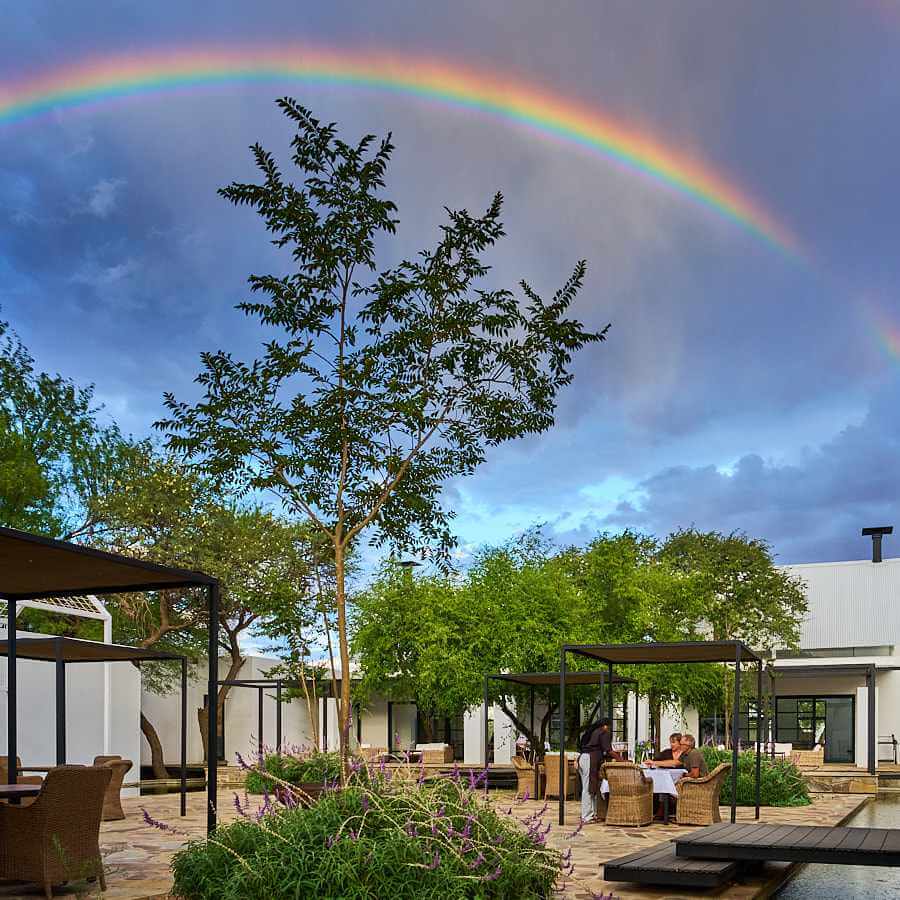 A rainbow extends over the Sandwerf restaurant, the remanence of a brief rain.