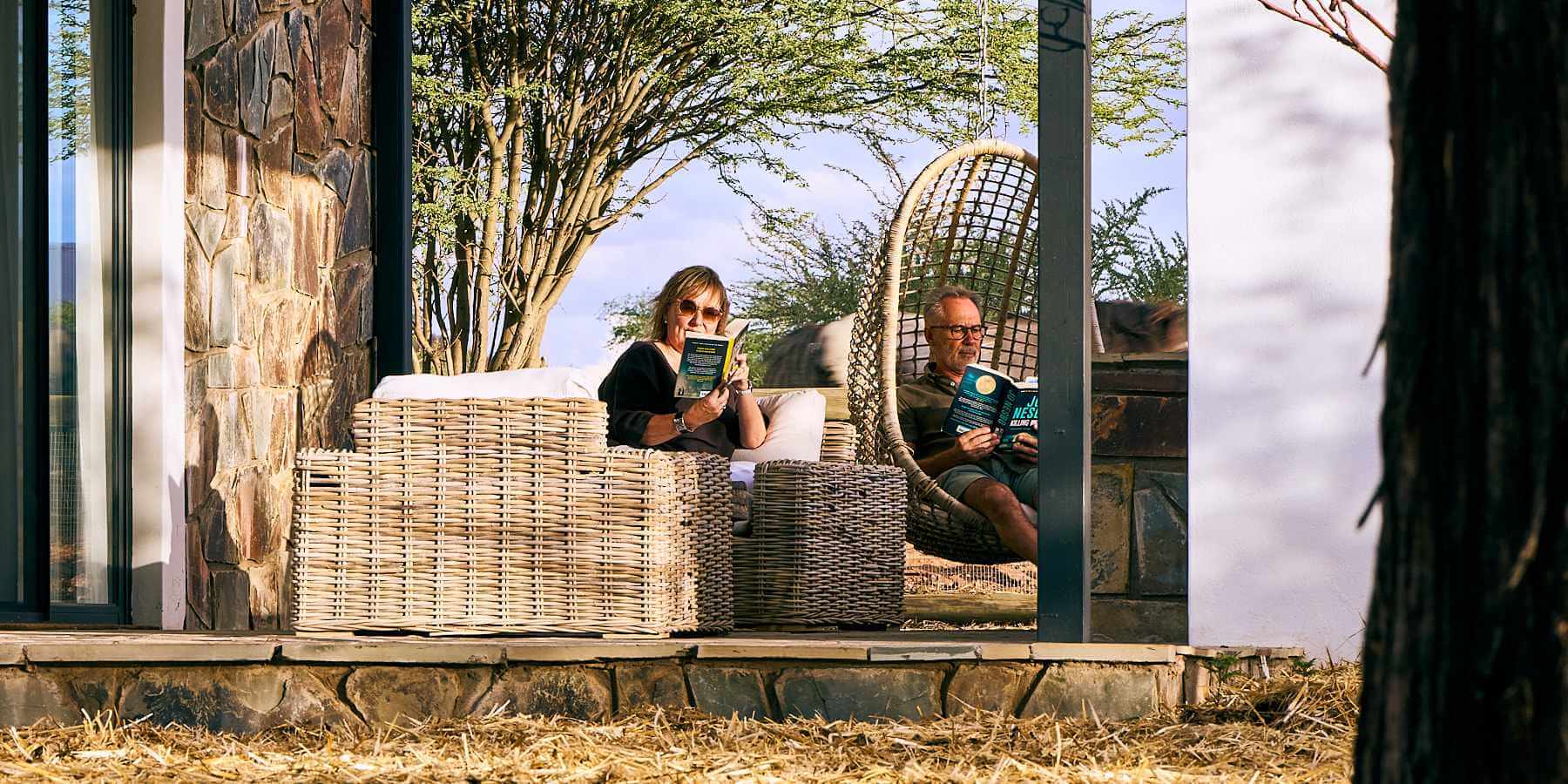 A couple relaxing on their private veranda after a fulfilled day's activities at Sandwerf.