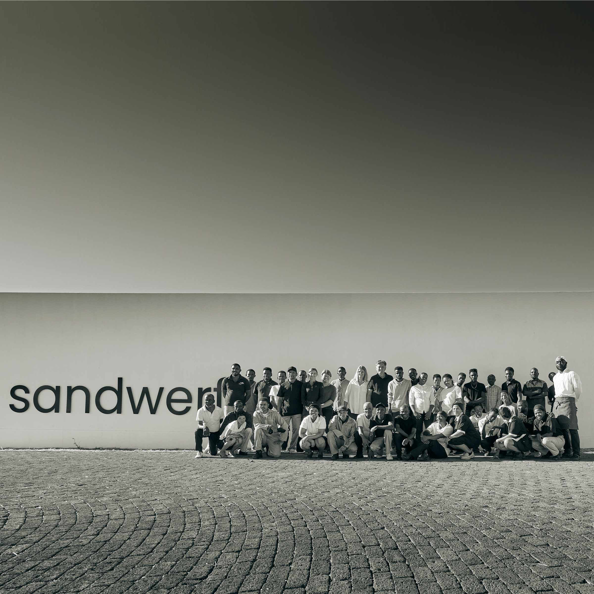 The dedicated community in front of the entrance sign of Sandwerf.