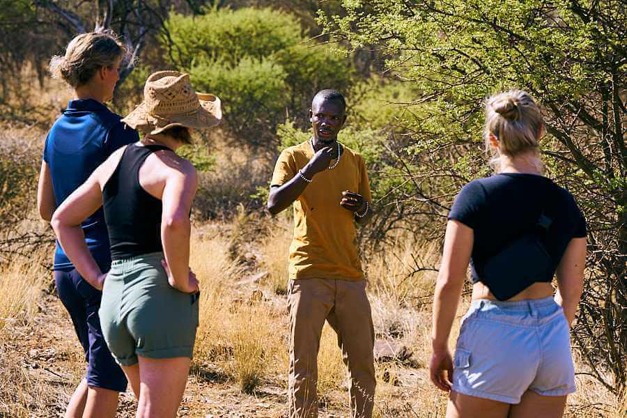 One of the Sandwerf guides explains the exciting facts of the Namibian wilderness to a group of visitors at Sandwerf.