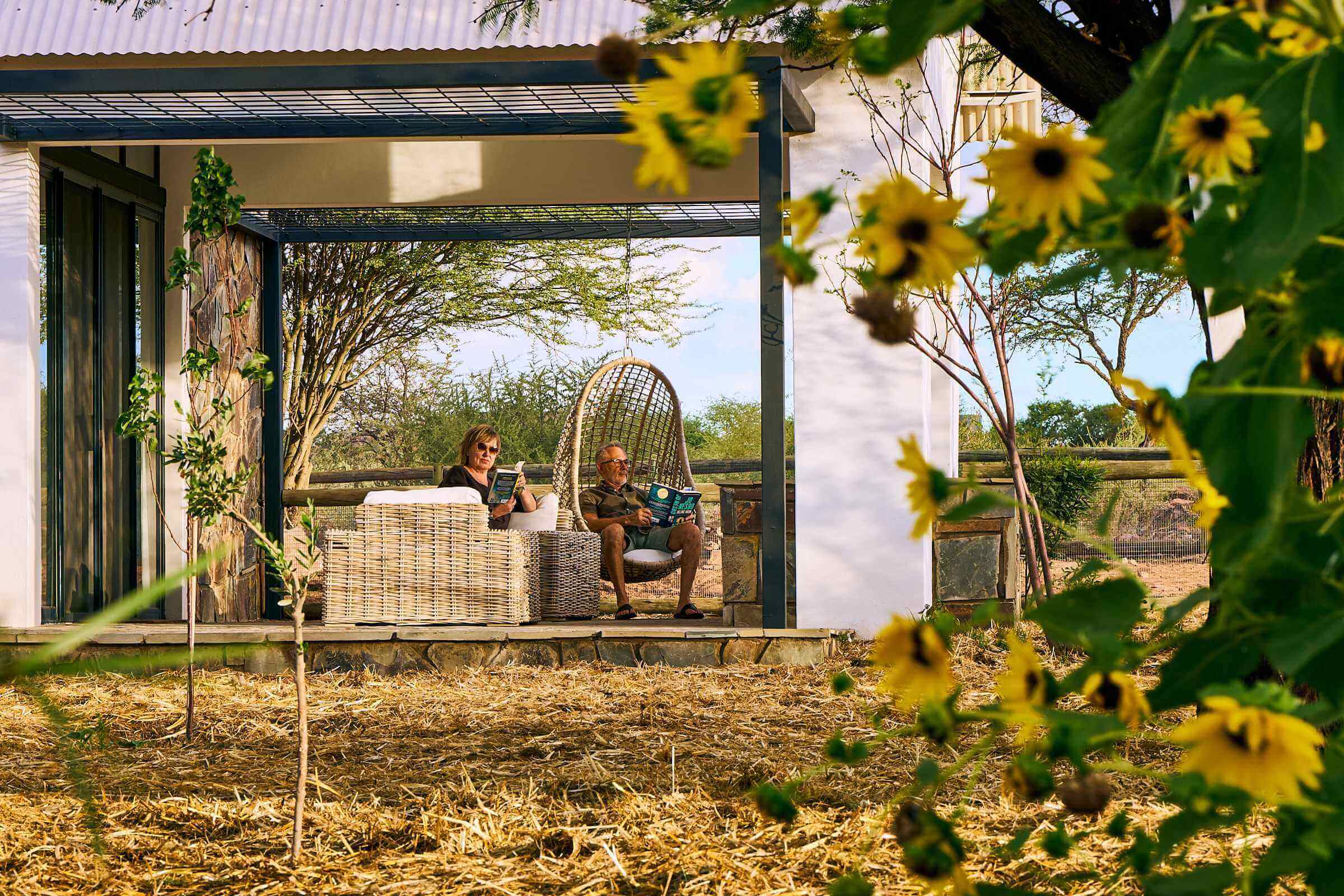 A couple soaks up the evening tranquillity from the comfort of their private veranda at one of the units at Sandwerf.